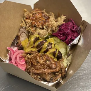 &quot; Smokers Club &quot; pulled pork, shredded brisket, beer braised bratwurst served with pickled cabbage and onions &amp; our house made sauerkraut.