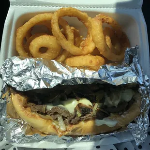 Philly steak sandwich with onion rings