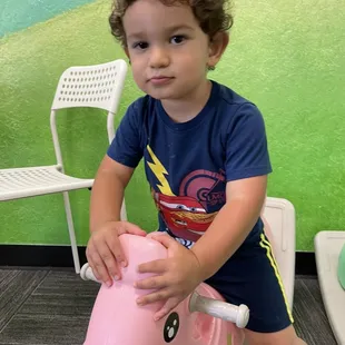 Luca playing on one of the many toy options they have!