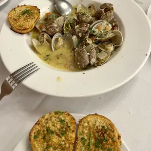 Steam clams with white wine, and garlic bread for appetizers