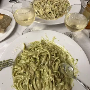 Linguine clams, as well as chicken fettuccine pesto with glass of Pinot Grigio