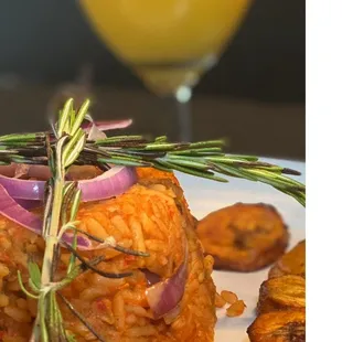 a plate of food and a glass of orange juice