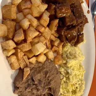 El Potosino - breakfast special of the morning with carne guisada, beans, potatoes, and eggs your way.