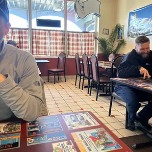 a man sitting at a table in a restaurant