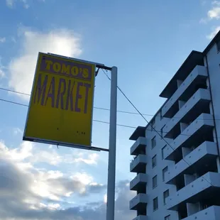 a yellow sign on a pole