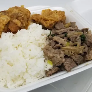 rice, meat, and vegetables in a styrofoam container