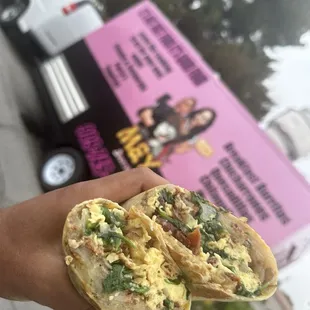 Sausage, bacon breakfast burrito. With spinach