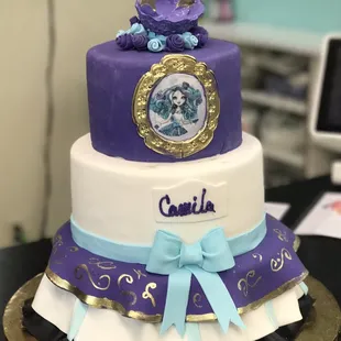 a three tiered cake with a picture on top
