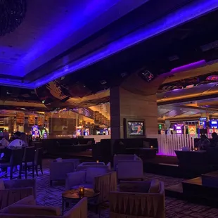 a bar and lounge area at night time