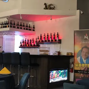 a bar with wine bottles on the wall