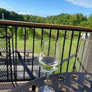 A glass of Madelyn (a asti/champagne style bubbly wine) on the back deck, overlooking the winery in mid-summer while enjoying live music.