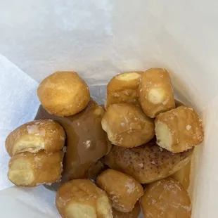 A half dozen donuts with a handful of donut holes to go with my order.  Enough donut holes that it almost covers the donuts.