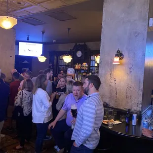  a large group of people in a bar