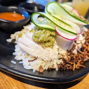 Hainan Chicken. $17. Poached chicken, cucumber salad, chili, and soy sauce. Singapore&apos;s national dish.