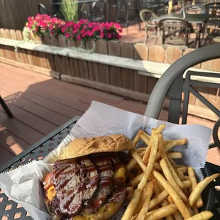 Smokin Burger--Smoked Brisket and BBQ on top of our braveheart burger served with fries .