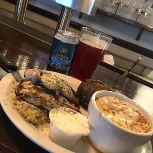 Grilled chicken smothered in a cheesy mushroom sauce , served over rice and your choice of sides .