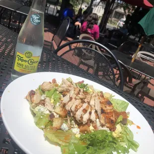 Our classic Moggers Salad topped with blackened chicken served with a Topo Chico on the side !