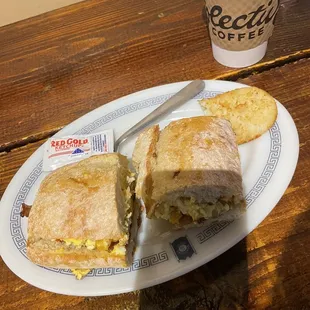 ows a breakfast sandwich and a cup of coffee