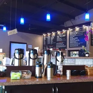 View of the ordering counter and coffee island from the seating area.