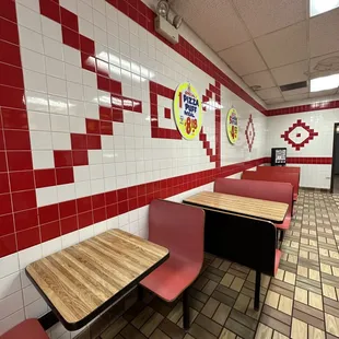 a restaurant with red and white tiles