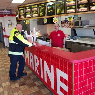 two men standing at a counter