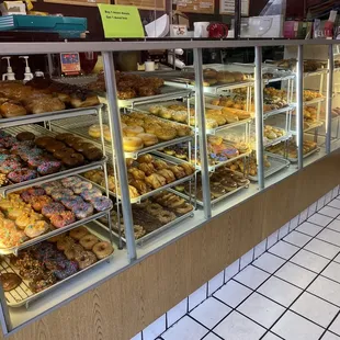 a variety of donuts in a display case