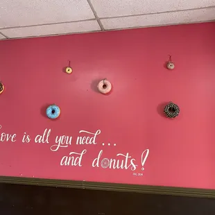 a pink wall with donuts on it