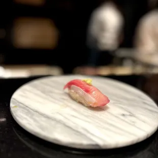 a sushi on a marble plate