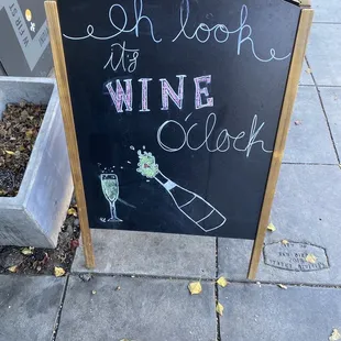 a chalkboard sign on a sidewalk