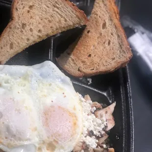 Chicken skillet with feta and over medium egg and wheat toast