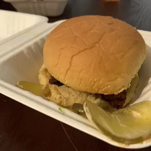 a hamburger with pickles