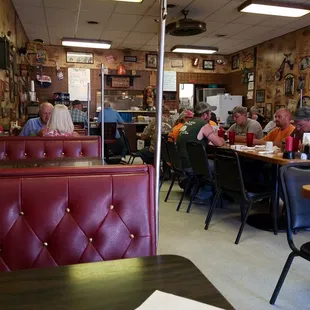 people sitting at tables in a restaurant
