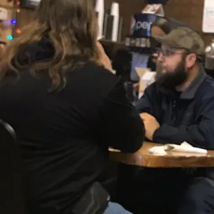 Table of 3 men smoking after they noticed the lady smoking