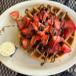 Belgium waffles with strawberries, Nutella and chocolate chips.