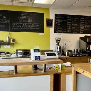 a man standing at a counter in a coffee shop