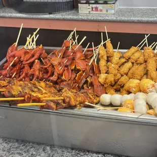 a variety of skewered food