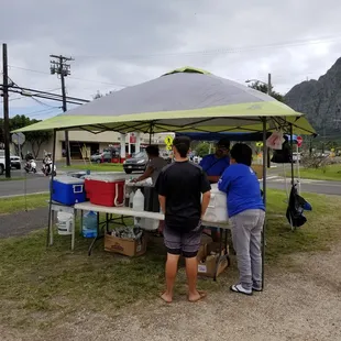 a group of people standing under a tent
