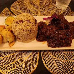 Braised oxtail with rice and peas and grilled veggies