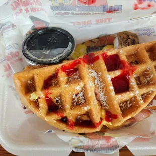 a waffle with raspberry sauce