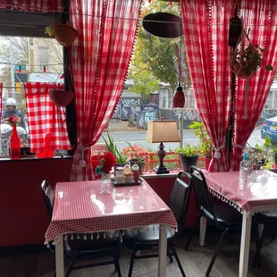 ows a red and white checkered table and chairs