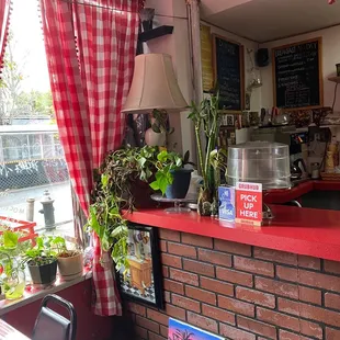 ows a red counter with a red countertop and a red brick wall
