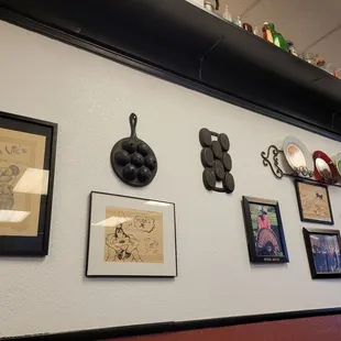 a wall of framed art