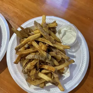 a plate of fries and a bowl of dip