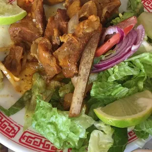 Goat dish (taken after attacking it first!) Plates apparently included from former Chinese restaurant at that location. Adds to the charm.