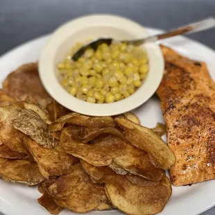 Grilled salmon with homemade chips and corn.