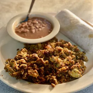 Chorizo and eggs. Side of pinto beans and tortillas.