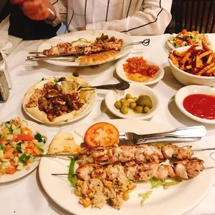 a woman sitting at a table full of food