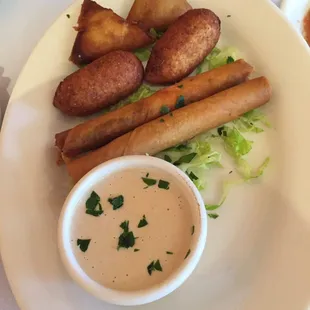 Combination appetizer plate. Cigars filled with ground meat, pastel filled w potato and kuba w/ ground meat. All crispy hot and good.
