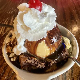a chocolate sundae with whipped cream and a cherry on top