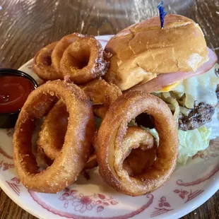 a plate of onion rings and a sandwich